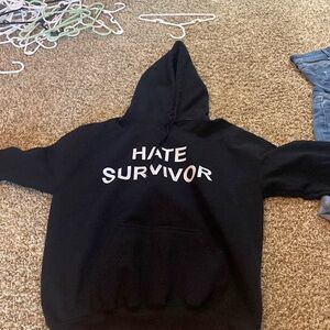 I’m selling a sweatshirt with the letters “HATE SURVIVOR” on it